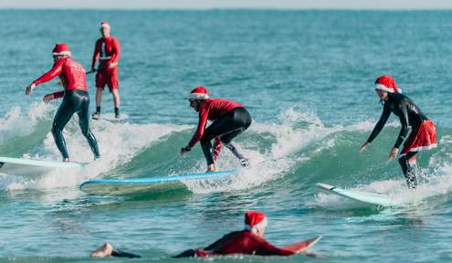 Brevard's Surfing Santas Continue Carving Their 24-Year Worldwide Legend